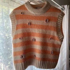 Peaches and cream sweater vest with pink flower details